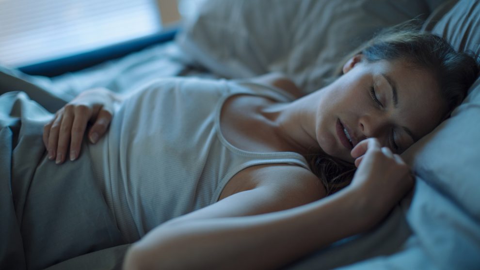 Close up of a woman sleeping on a bed